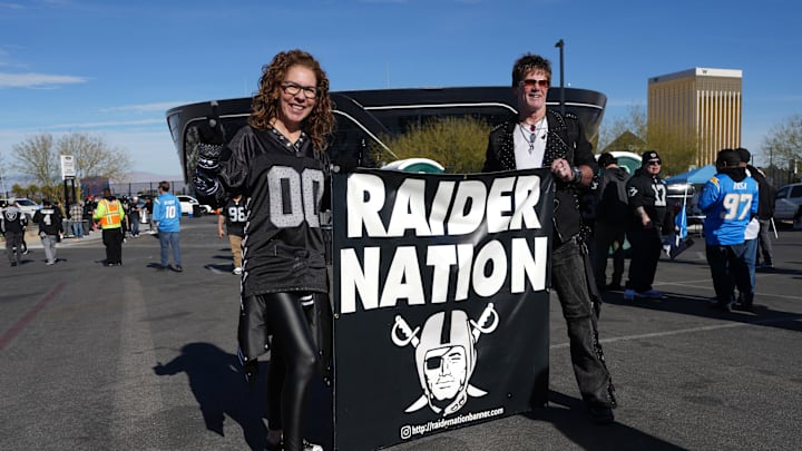 Jan 5, 2025; Paradise, Nevada, USA; Las Vegas Raiders fans hold a Raider Nation banner during tailgate festivities before the game against the Los Angeles Chargers at Allegiant Stadium. Mandatory Credit: Kirby Lee-Imagn Images