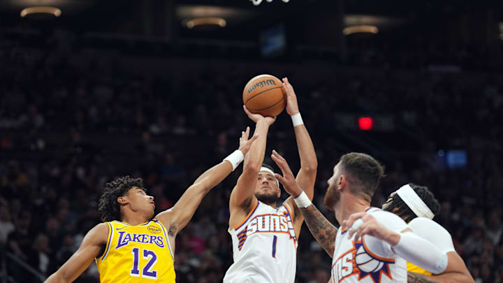 Oct 17, 2024; Phoenix, Arizona, USA; Phoenix Suns guard Devin Booker (1) shoots over Los Angeles Lakers guard Max Christie (12) during the first half at Footprint Center. Mandatory Credit: Joe Camporeale-Imagn Images