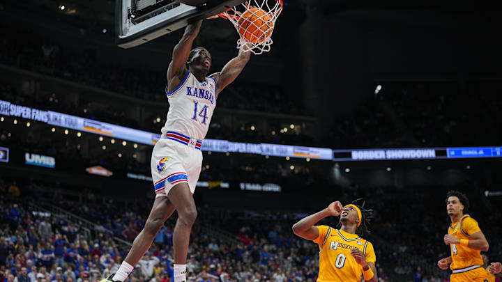 Dec 7, 2025; Kansas City, Missouri, USA; Kansas Jayhawks guard Melvin Council Jr. (14) dunks the ball during the first half against the Missouri Tigers at T-Mobile Center. Mandatory Credit: Jay Biggerstaff-Imagn Images
