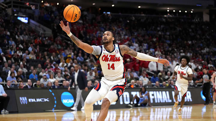 Mar 21, 2025; Milwaukee, WI, USA; Mississippi Rebels guard Dre Davis (14) grabs a loose ball during the second half of a first round NCAA men’s tournament game against the North Carolina Tar Heels at Fiserv Forum. Mandatory Credit: Jeff Hanisch-Imagn Images