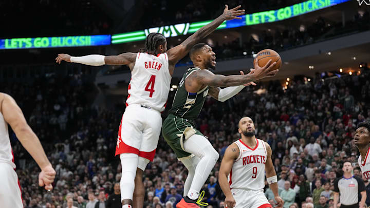 Nov 18, 2024; Milwaukee, Wisconsin, USA; Houston Rockets guard Aaron Holiday (0) shoots in front of Houston Rockets guard Jalen Green (4) during the fourth quarter at Fiserv Forum. Mandatory Credit: Jeff Hanisch-Imagn Images Nov 18, 2024; Milwaukee, Wisconsin, USA; Houston Rockets guard Aaron Holiday (0) shoots in front of Houston Rockets guard Jalen Green (4) during the fourth quarter at Fiserv Forum. Mandatory Credit: Jeff Hanisch-Imagn Images