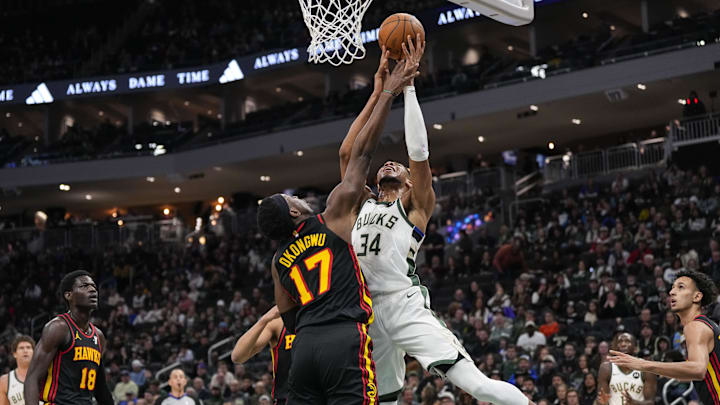 Mar 30, 2025; Milwaukee, Wisconsin, USA;  Milwaukee Bucks forward Giannis Antetokounmpo (34) shoots against Atlanta Hawks center Onyeka Okongwu (17) during the first quarter at Fiserv Forum. Mandatory Credit: Jeff Hanisch-Imagn Images