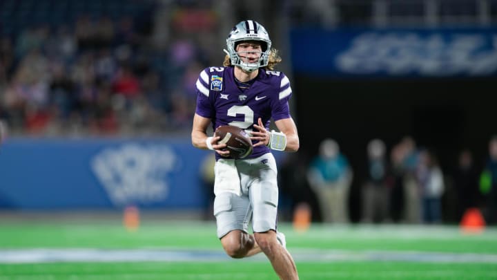 Dec 28, 2023; Orlando, FL, USA; Kansas State quarterback Avery Johnson (2) runs the ball against NC State in the second quarter at Camping World Stadium. Mandatory Credit: Jeremy Reper-USA TODAY Sports