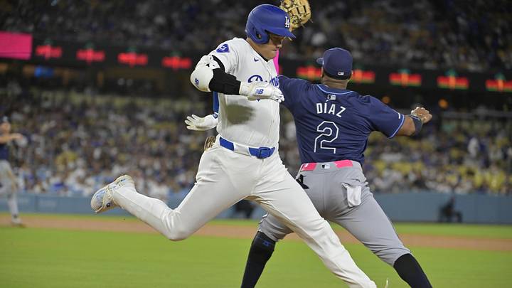 Aug 23, 2024; Los Angeles, California, USA;  Los Angeles Dodgers designated hitter Shohei Ohtani (17) beats the throw to Tampa Bay Rays first baseman Yandy Diaz (2) for a single in the fourth inning at Dodger Stadium. Mandatory Credit: Jayne Kamin-Oncea-Imagn Images