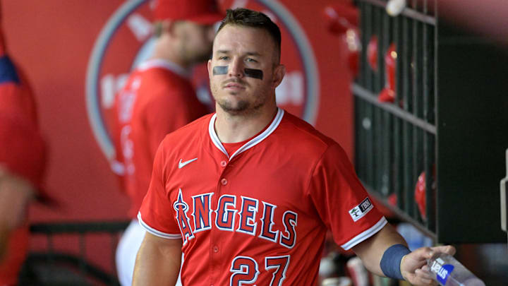Mar 24, 2025; Anaheim, California, USA;  Los Angeles Angels center fielder Mike Trout (27) looks on from the dugout against the Los Angeles Dodgers at Angel Stadium. Mandatory Credit: Jayne Kamin-Oncea-Imagn Images