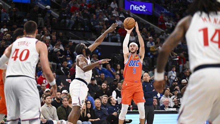 Nov 2, 2024; Inglewood, California, USA; Oklahoma City Thunder guard Alex Caruso (9) shoots against LA Clippers guard James Harden (1) during the second half at Intuit Dome. Mandatory Credit: Jonathan Hui-Imagn Images