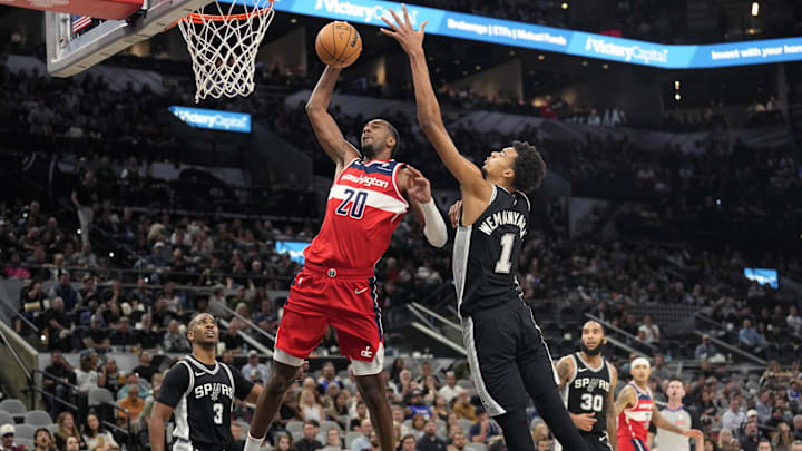 Nov 13, 2024; San Antonio, Texas, USA; Washington Wizards forward Alex Sarr (20) goes up to dunk while defended by San Antonio Spurs center Victor Wembanyama (1) during the second half at Frost Bank Center. Mandatory Credit: Scott Wachter-Imagn Images