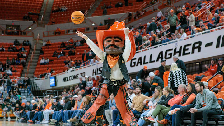 Jan 23, 2024; Stillwater, Oklahoma, USA; Oklahoma State Cowboys mascot Pistol Pete takes a shot before the game against the TCU Horned Frogs at Gallagher-Iba Arena. Mandatory Credit: William Purnell-Imagn Images