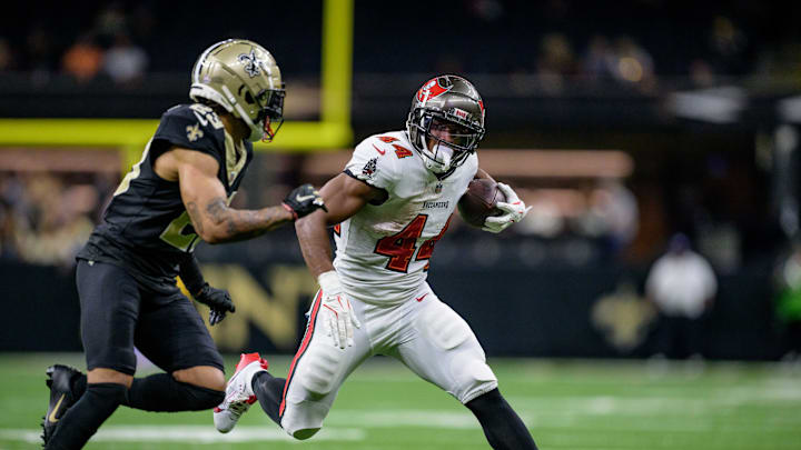 Oct 13, 2024; New Orleans, Louisiana, USA; Tampa Bay Buccaneers running back Sean Tucker (44) runs against New Orleans Saints cornerback Marshon Lattimore (23) during the fourth quarter at Caesars Superdome. Mandatory Credit: Matthew Hinton-Imagn Images