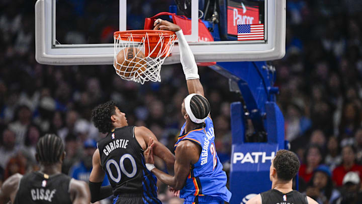 Mar 1, 2026; Dallas, Texas, USA; Oklahoma City Thunder guard Shai Gilgeous-Alexander (2) dunks the ball over Dallas Mavericks guard Max Christie (00) during the second quarter at the American Airlines Center. Mandatory Credit: Jerome Miron-Imagn Images