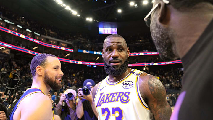 Jan 25, 2025; San Francisco, California, USA; Los Angeles Lakers forward LeBron James (23) talks with Golden State Warriors guard Stephen Curry (left) and forward Draymond Green (right) after the game at Chase Center. Mandatory Credit: Darren Yamashita-Imagn Images