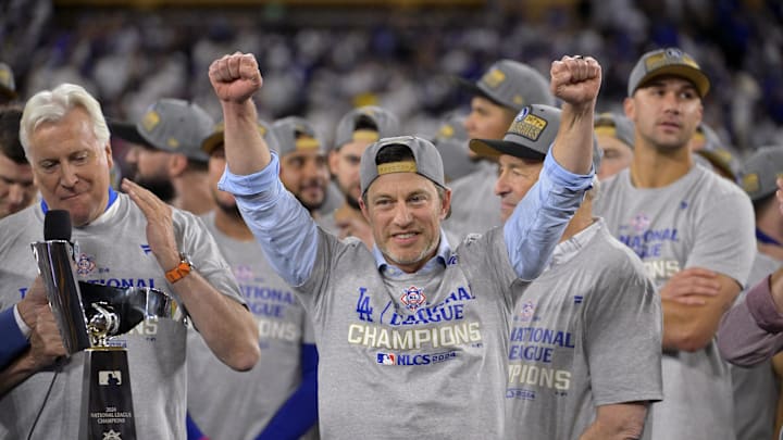 Oct 20, 2024; Los Angeles, California, USA; Los Angeles Dodgers president of baseball operations Andrew Friedman celebrates on the podium after the win against the New York Mets in game six of the NLCS to advance to the World Series in the 2024 MLB playoffs at Dodger Stadium. Mandatory Credit: Jayne Kamin-Oncea-Imagn Images