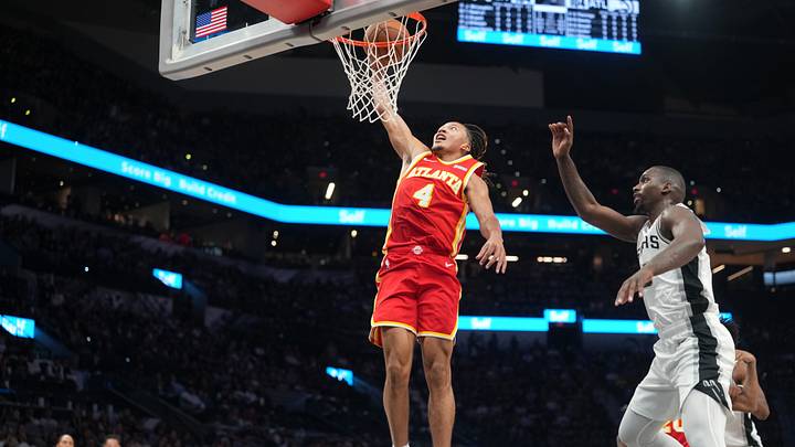 Oct 8, 2026; San Antonio, Texas, USA;  Atlanta Hawks guard Kingston Flemings (4) dunks over San Antonio Spurs guard David Jones Garcia (25) during the second half at Frost Bank Center.  Mandatory Credit: Scott Wachter-Imagn Images