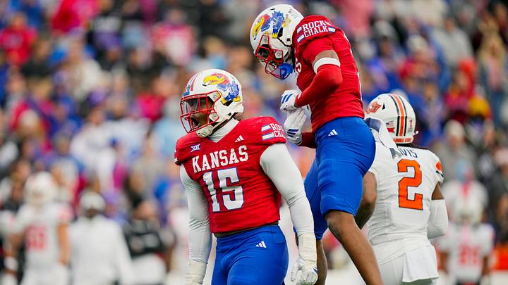 Nov 1, 2025; Lawrence, Kansas, USA; Kansas Jayhawks defensive end Justice Finkley (15) celebrates with safety Lyrik Rawls (2) after a play during the second half against the Oklahoma State Cowboys at David Booth Kansas Memorial Stadium. Mandatory Credit: Jay Biggerstaff-Imagn Images Nov 1, 2025; Lawrence, Kansas, USA; Kansas Jayhawks defensive end Justice Finkley (15) celebrates with safety Lyrik Rawls (2) after a play during the second half against the Oklahoma State Cowboys at David Booth Kansas Memorial Stadium. Mandatory Credit: Jay Biggerstaff-Imagn Images