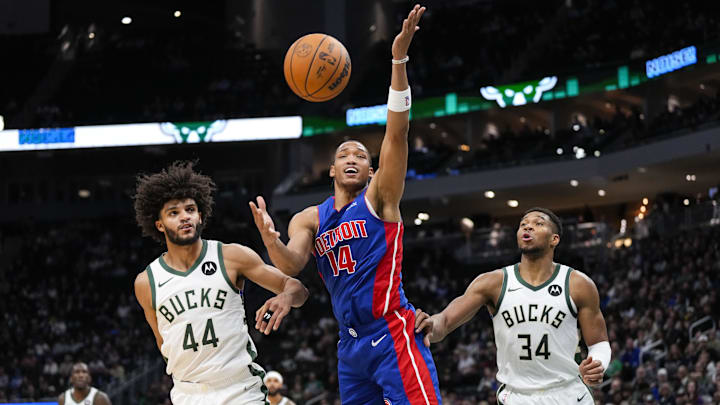 Nov 13, 2024; Milwaukee, Wisconsin, USA;  Detroit Pistons guard Wendell Moore Jr. (14) reaches for the ball in front of Milwaukee Bucks guard Andre Jackson Jr. (44) and forward Giannis Antetokounmpo (34) during the third quarter at Fiserv Forum. Mandatory Credit: Jeff Hanisch-Imagn Images
