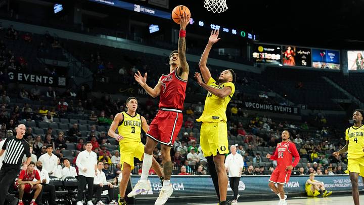 Nov 25, 2025; Las Vegas, Nevada, USA; San Diego State Aztecs guard Elzie Harrington (3) shoots while being defended by Oregon Ducks forward Kwame Evans Jr. (10) in the second half in a 2025 Players Era Festival group play game at Michelob Ultra Arena. Mandatory Credit: Kirby Lee-Imagn Images