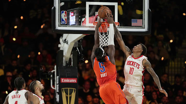 Dec 14, 2024; Las Vegas, Nevada, USA; Oklahoma City Thunder guard Luguentz Dort (5) shoots against Houston Rockets forward Jabari Smith Jr. (10) during the fourth quarter in a semifinal of the 2024 Emirates NBA Cup at T-Mobile Arena. Mandatory Credit: Kyle Terada-Imagn Images