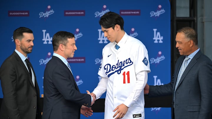 Jan 22, 2025; Los Angeles, CA, USA; L-R; Brandon Gomes, president of baseball operations, general manager Andrew Friedman, and manager Dave Roberts (30) shake hands with Los Angeles Dodgers pitcher Roki Sasaki (11) during an introductory press conference at Dodger Stadium. Mandatory Credit: Jayne Kamin-Oncea-Imagn Images Jan 22, 2025; Los Angeles, CA, USA; L-R; Brandon Gomes, president of baseball operations, general manager Andrew Friedman, and manager Dave Roberts (30) shake hands with Los Angeles Dodgers pitcher Roki Sasaki (11) during an introductory press conference at Dodger Stadium. Mandatory Credit: Jayne Kamin-Oncea-Imagn Images