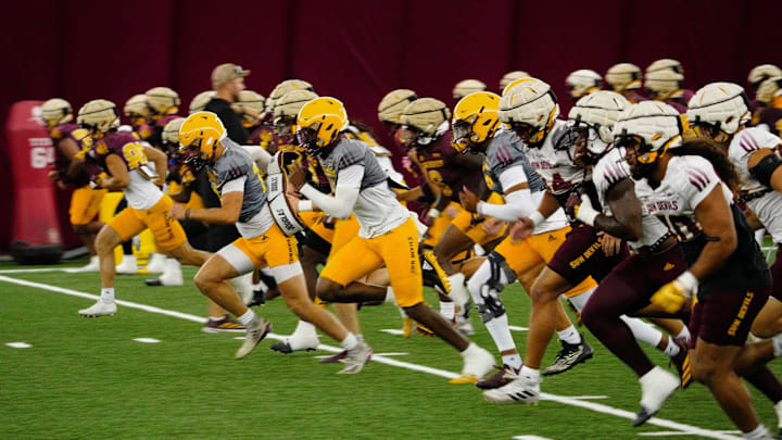 Arizona State players warm up during a practice inside the Verde Dickey Dome in Tempe on Aug. 12, 2025.