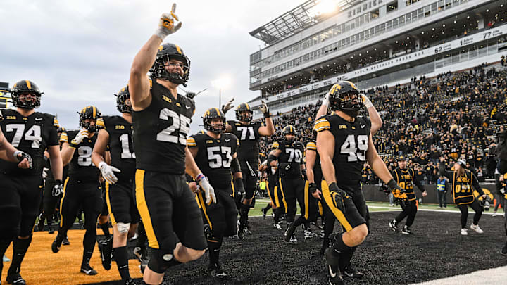 Oct 25, 2025; Iowa City, Iowa, USA; Iowa Hawkeyes linebacker Kelby Telander (25) and defensive lineman Ethan Hurkett (49) and the rest of the team react after the game against the Minnesota Golden Gophers at Kinnick Stadium. Mandatory Credit: Jeffrey Becker-Imagn Images Oct 25, 2025; Iowa City, Iowa, USA; Iowa Hawkeyes linebacker Kelby Telander (25) and defensive lineman Ethan Hurkett (49) and the rest of the team react after the game against the Minnesota Golden Gophers at Kinnick Stadium. Mandatory Credit: Jeffrey Becker-Imagn Images