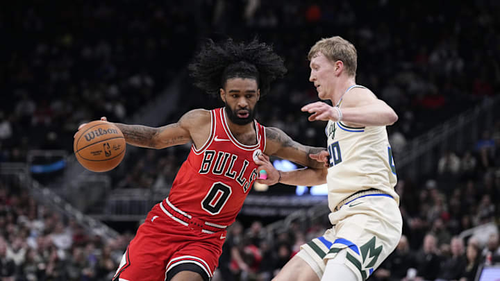 Feb 3, 2026; Milwaukee, Wisconsin, USA; Chicago Bulls guard Coby White (0) drives to the basket against Milwaukee Bucks guard AJ Green (20) in the first half at Fiserv Forum. Mandatory Credit: Michael McLoone-Imagn Images