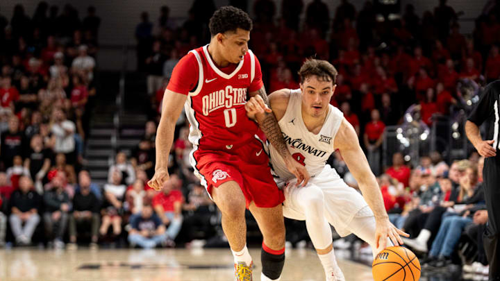 Cincinnati Bearcats guard Connor Hickman (8) drives on Ohio State Buckeyes guard John Mobley Jr. (0) in the second half of a basketball scrimmage between Cincinnati Bearcats and Ohio State Buckeyes at Fifth Third Arena in Cincinnati on Friday, Oct. 18, 2024.