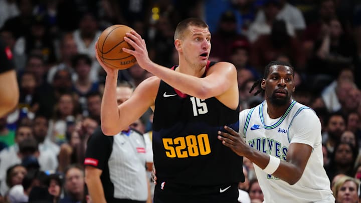 Minnesota Timberwolves center Naz Reid (11) defends Denver Nuggets center Nikola Jokic (15) in the first half in game seven of the second round for the 2024 NBA playoffs at Ball Arena. Mandatory Credit: Ron Chenoy-Imagn Images