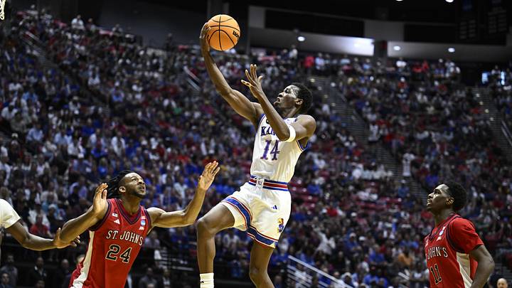 Mar 22, 2026; San Diego, CA, USA; Kansas Jayhawks guard Melvin Council Jr. (14) shoots against St. John's Red Storm forward Zuby Ejiofor (24) in the first half during a second round game of the men's 2026 NCAA Tournament at Viejas Arena. Mandatory Credit: Denis Poroy-Imagn Images
