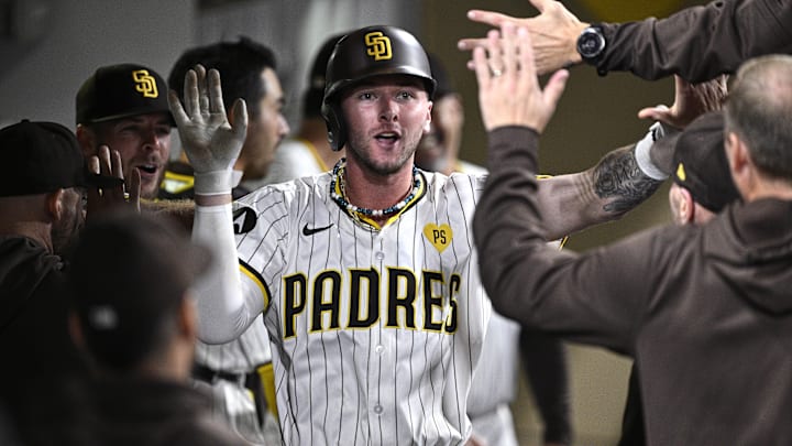 Sep 16, 2024; San Diego, California, USA; San Diego Padres center fielder Jackson Merrill (3) is congratulated in the dugout after hitting a home run against the Houston Astros during the fourth inning at Petco Park.