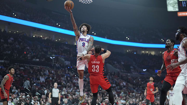 Dec 30, 2024; Portland, Oregon, USA; Philadelphia 76ers shooting guard Kelly Oubre Jr. (9) shoots the ball against Portland Trail Blazers forward Toumani Camara (33) during the first half at Moda Center. Mandatory Credit: Soobum Im-Imagn Images