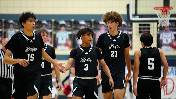 Jan. 12, 2024; Phoenix, Ariz; USA; Sunnyslope guards Rider Portela (15) and Delton Prescott (3) high-five and celebrate with teammate Darius Wabbington (21) during a game at Pinnacle High School.