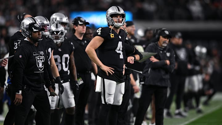 Jan 9, 2022; Paradise, Nevada, USA; Las Vegas Raiders quarterback Derek Carr (4) looks on from the sideline during the second half against the Los Angeles Chargers at Allegiant Stadium. Mandatory Credit: Orlando Ramirez-Imagn Images