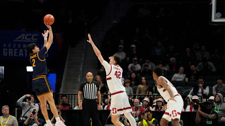 Mar 12, 2025; Charlotte, NC, USA; California Golden Bears guard Andrej Stojakovic (2) shoots as Stanford Cardinal forward Maxime Raynaud (42) defends in the first half at Spectrum Center. Mandatory Credit: Bob Donnan-Imagn Images