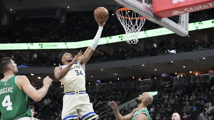 Bucks forward Giannis Antetokounmpo lays up a shot against Celtics guard Derrick White. Bucks forward Giannis Antetokounmpo lays up a shot against Celtics guard Derrick White.