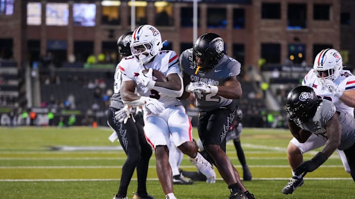 Nov 1, 2025; Boulder, Colorado, USA; Arizona Wildcats running back Kedrick Reescano (3) scores a touchdown past Colorado Buffaloes linebacker Jeremiah Brown (42) in the second half at Folsom Field. Mandatory Credit: Ron Chenoy-Imagn Images