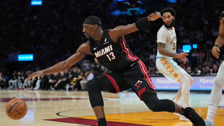 Jan 19, 2025; Miami, Florida, USA;  Miami Heat center Bam Adebayo (13) reaches for a loose ball during the second half against the San Antonio Spurs at Kaseya Center. Mandatory Credit: Jim Rassol-Imagn Images