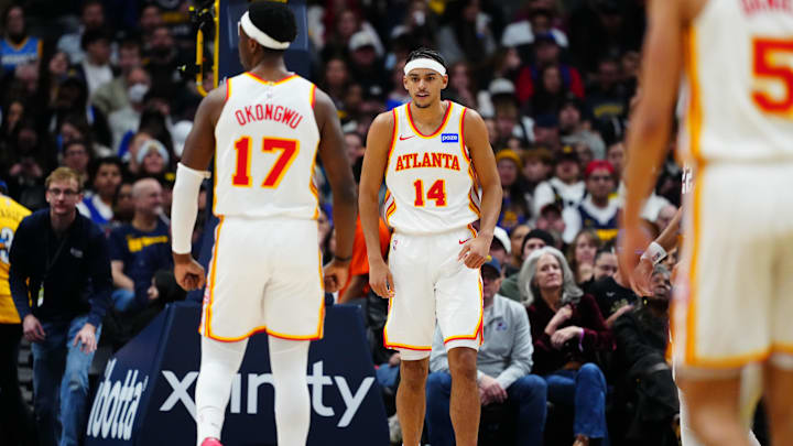 Jan 9, 2026; Denver, Colorado, USA;Atlanta Hawks forward Asa Newell (14) reacts after his dunk in the second quarter against the Denver Nuggets at Ball Arena. Mandatory Credit: Ron Chenoy-Imagn Images