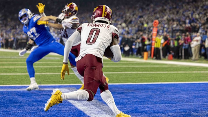 Jan 18, 2025; Detroit, Michigan, USA;  Washington Commanders cornerback Mike Sainristil (0) runs the ball out of the endzone during the second quarter against Detroit Lions at Ford Field. Mandatory Credit: David Reginek-Imagn Images