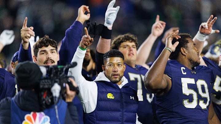 Notre Dame head coach Marcus Freeman celebrates with his players after winning a NCAA football game 70-7 against Syracuse at Notre Dame Stadium on Saturday, Nov. 22, 2025, in South Bend.