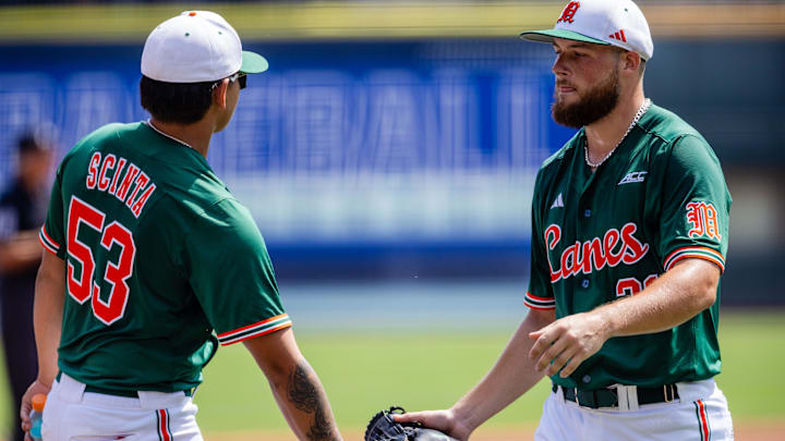 May 23, 2024; Charlotte, NC, USA; Miami (Fl) Hurricanes pitcher Gage Ziehl (31) gets congratulated by pitcher Chris Scinta (53) after finishing the first inning against the Clemson Tigers during the ACC Baseball Tournament at Truist Field. Mandatory Credit: Scott Kinser-Imagn Images
