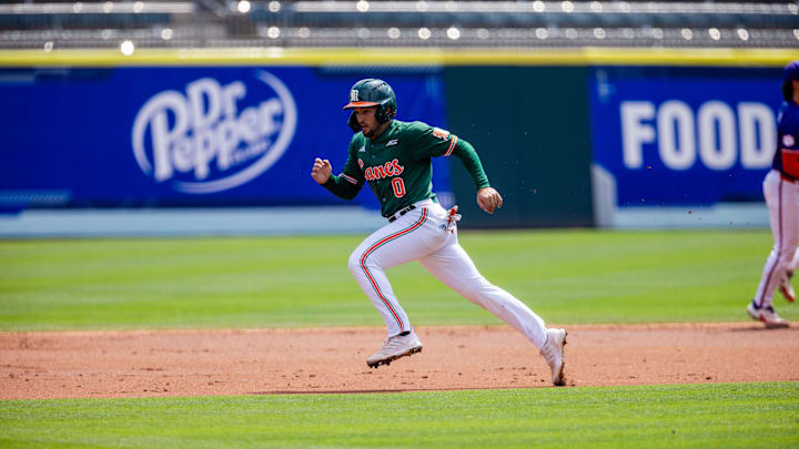 May 23, 2024; Charlotte, NC, USA; Miami (Fl) Hurricanes infielder Dorian Gonzalez Jr. (0) runs to third against the Clemson Tigers during the second inning during the ACC Baseball Tournament at Truist Field. Mandatory Credit: Scott Kinser-Imagn Images
