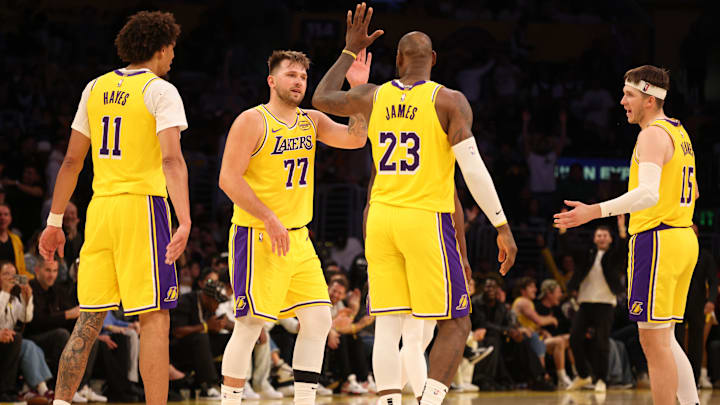 Feb 27, 2025; Los Angeles, California, USA: Los Angeles Lakers guard Luka Doncic (77) celebrates with forward LeBron James (23) after making a basket during the fourth quarter against the Minnesota Timberwolves at Crypto.com Arena. Mandatory Credit: Jason Parkhurst-Imagn Images