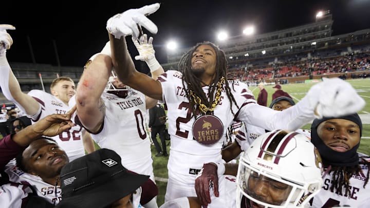Texas State safety Bobby Crosby (27) reacts with his teammates after an interception against Rice.