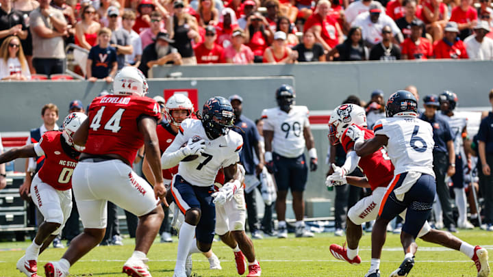 Sep 6, 2025; Raleigh, North Carolina, USA;Virginia Cavaliers wide receiver Jahmal Edrine (7) runs with the football during the first half of the game against North Carolina State Wolfpack at Carter-Finley Stadium. Mandatory Credit: Jaylynn Nash-Imagn Images Sep 6, 2025; Raleigh, North Carolina, USA;Virginia Cavaliers wide receiver Jahmal Edrine (7) runs with the football during the first half of the game against North Carolina State Wolfpack at Carter-Finley Stadium. Mandatory Credit: Jaylynn Nash-Imagn Images
