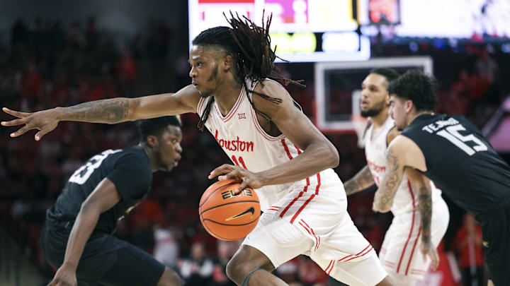 Nov 8, 2025; Houston, Texas, USA; Houston Cougars forward Joseph Tugler (11) drives with the ball during the second half against the Towson Tigers at Fertitta Center. Mandatory Credit: Troy Taormina-Imagn Images