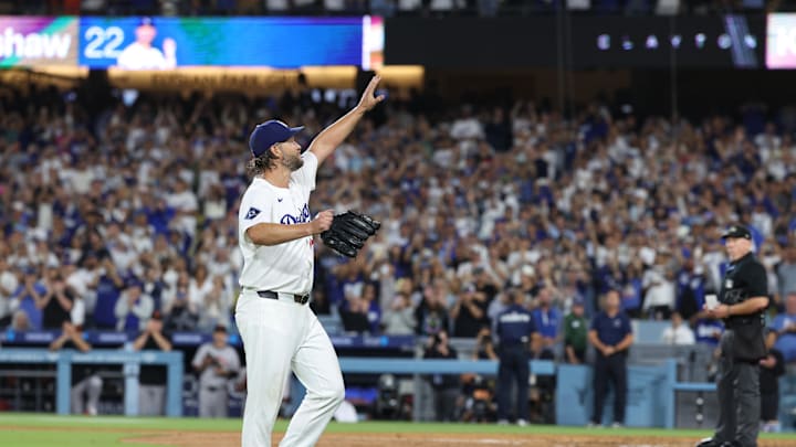 Sep 19, 2025; Los Angeles, California, USA; Los Angeles Dodgers pitcher Clayton Kershaw (22) salutes the crowd after being relieved during the fifth inning against the San Francisco Giants at Dodger Stadium. Mandatory Credit: Kiyoshi Mio-Imagn Images