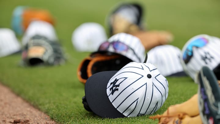 Feb 20, 2025; Tampa, FL, USA; A general view of New York Yankees players hats and gloves on the field during workouts at George M. Steinbrenner Field. Mandatory Credit: Kim Klement Neitzel-Imagn Images