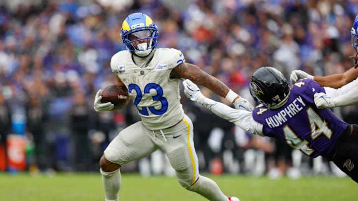 Oct 12, 2025; Baltimore, Maryland, USA; Los Angeles Rams running back Kyren Williams (23) avoids a tackle by Baltimore Ravens cornerback Marlon Humphrey (44) during the second half of the game at M&T Bank Stadium. Mandatory Credit: Peter Casey-Imagn Images