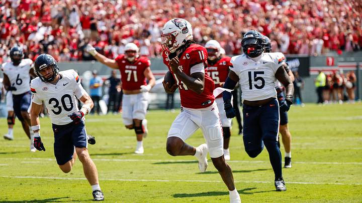 Sep 6, 2025; Raleigh, North Carolina, USA; North Carolina State Wolfpack quarterback CJ Bailey (11) runs with the football to make a touchdown during the first half of the game against Virginia Cavaliers at Carter-Finley Stadium. Mandatory Credit: Jaylynn Nash-Imagn Images Sep 6, 2025; Raleigh, North Carolina, USA; North Carolina State Wolfpack quarterback CJ Bailey (11) runs with the football to make a touchdown during the first half of the game against Virginia Cavaliers at Carter-Finley Stadium. Mandatory Credit: Jaylynn Nash-Imagn Images