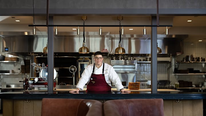 Britt Rescigno stands in front of Fiamma's open kitchen
